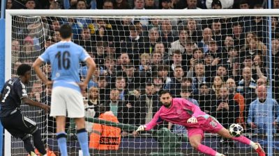 Pemain Real Madrid Vinicius Junior mengeksekusi tendangan penalti ke gawang kiper Manchester City Gianluigi Donnarumma.