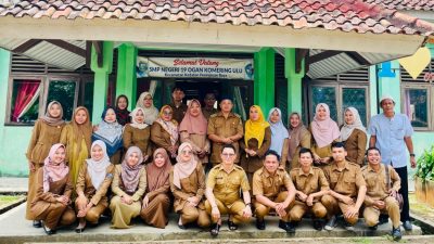 Foto bersama puluhan dewan guru berseragam dinas di depan gedung SMP NEGERI 19 OGAN KOMERING ULU.